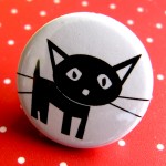 close up of lucky black cat badge