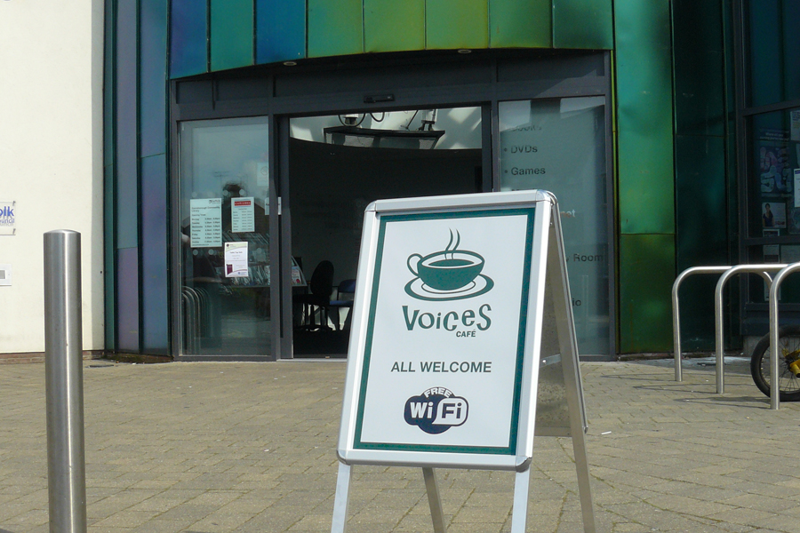 Voices Cafe logo in use on a display board outside the library