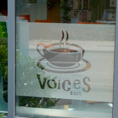 The new Voices Cafe logo on a window vinyl